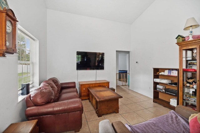 living room featuring high vaulted ceiling and light tile patterned floors