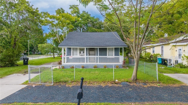 view of front of property with covered porch and a front lawn