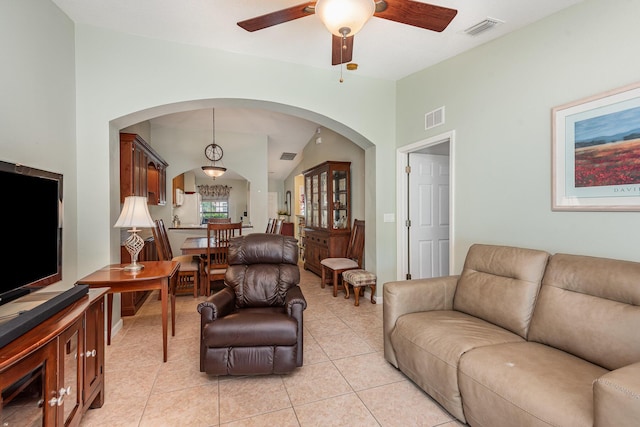 tiled living room with lofted ceiling and ceiling fan