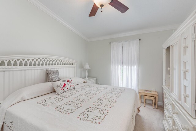 carpeted bedroom featuring ceiling fan and ornamental molding