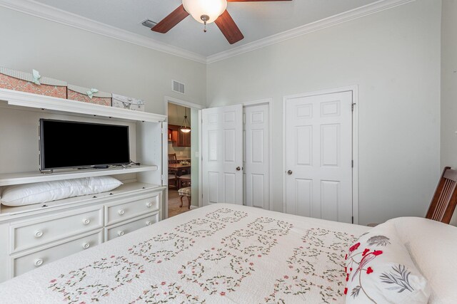 carpeted bedroom featuring ceiling fan and ornamental molding