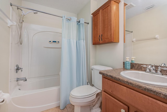 full bathroom featuring a textured ceiling, shower / bath combo with shower curtain, toilet, vanity, and tile patterned flooring