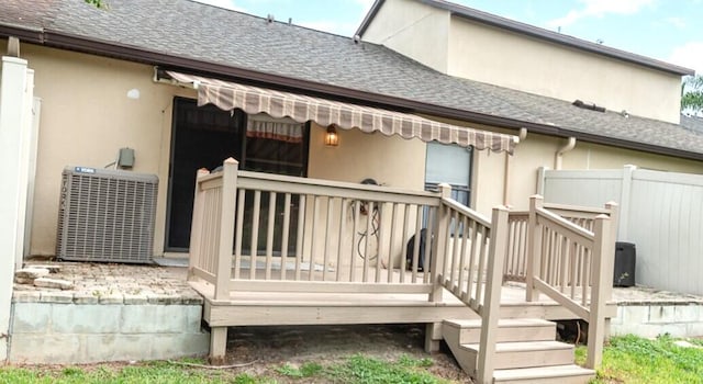 rear view of property featuring central air condition unit