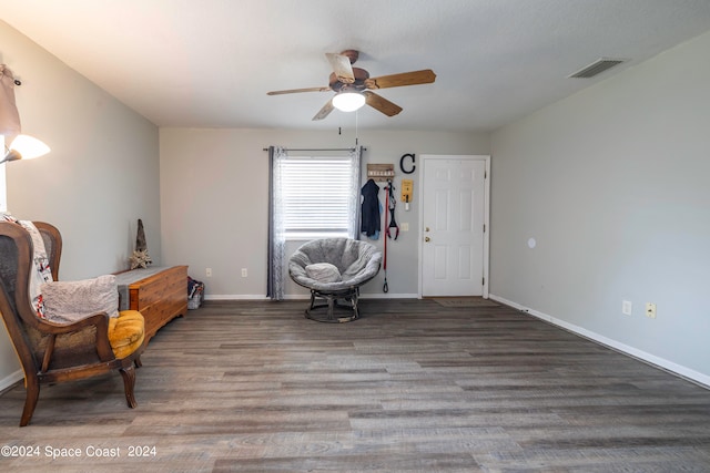 living area featuring ceiling fan and wood-type flooring