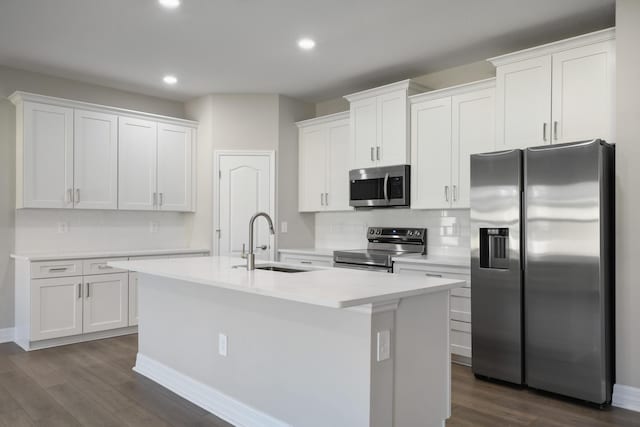 kitchen with appliances with stainless steel finishes, sink, and white cabinets