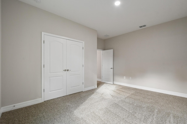 unfurnished bedroom featuring a closet and carpet