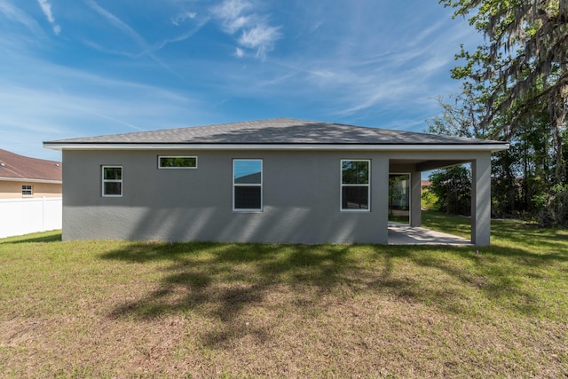 back of property featuring a lawn