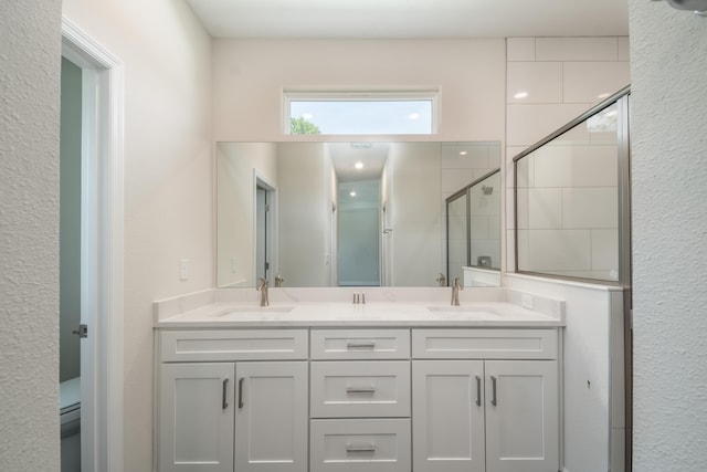 bathroom featuring an enclosed shower and vanity