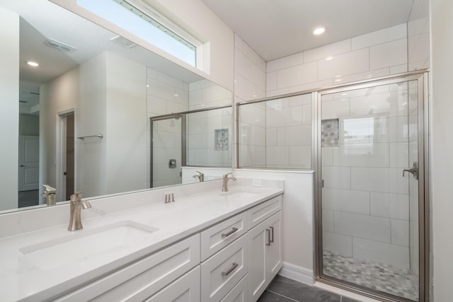 bathroom featuring vanity and a shower with door