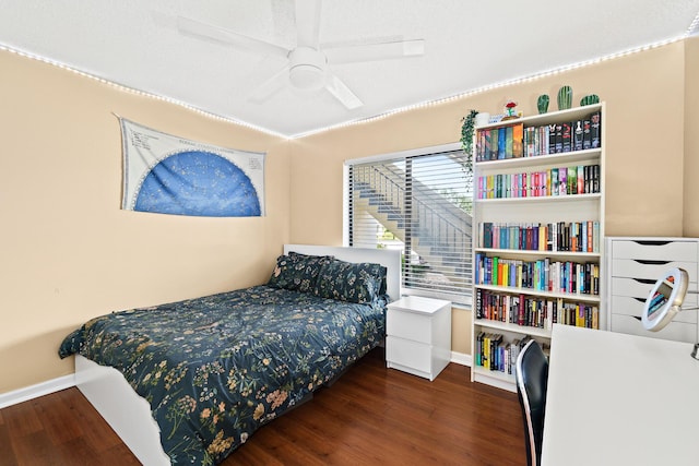 bedroom with dark wood-type flooring and ceiling fan