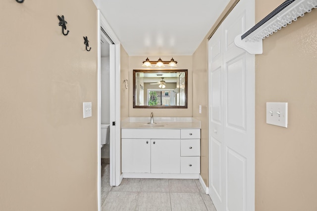 bathroom featuring tile patterned floors, vanity, and toilet