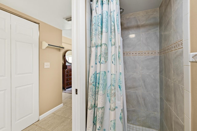 bathroom with tile patterned floors and walk in shower