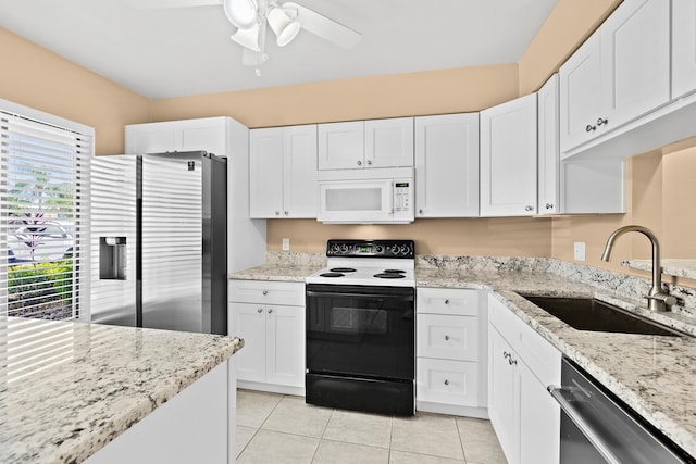 kitchen featuring stainless steel appliances, white cabinetry, sink, and light stone counters