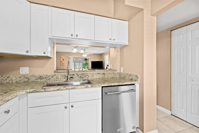 kitchen with dishwasher, sink, light tile patterned floors, and white cabinets