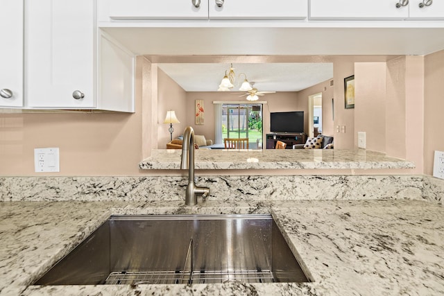 kitchen featuring white cabinetry, sink, and ceiling fan