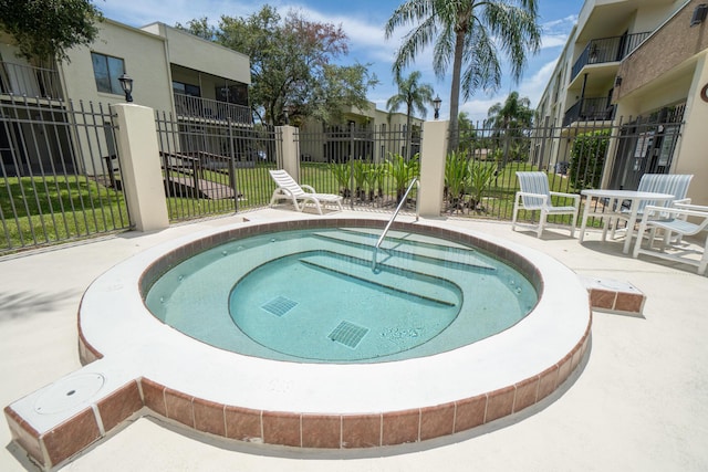 view of swimming pool featuring a community hot tub and a patio