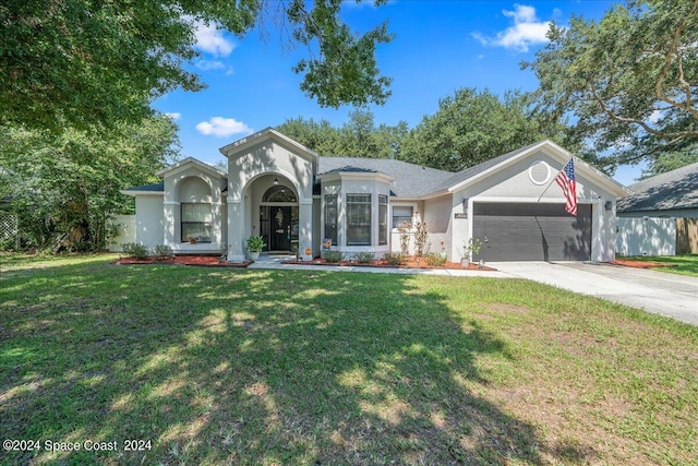 view of front of home featuring a garage and a front yard