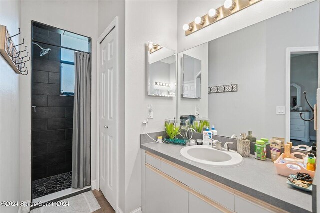 bathroom featuring curtained shower and vanity