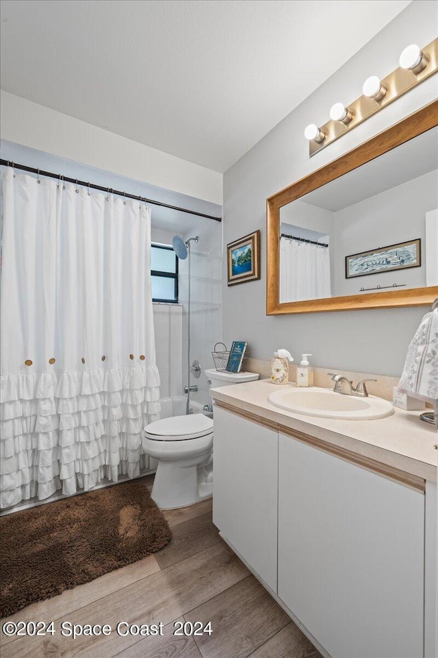 full bathroom featuring shower / tub combo with curtain, vanity, toilet, and hardwood / wood-style flooring