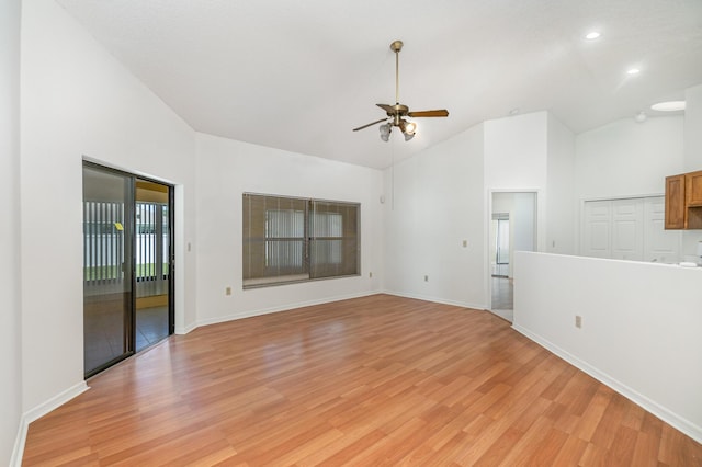 spare room featuring ceiling fan, high vaulted ceiling, and light wood-type flooring