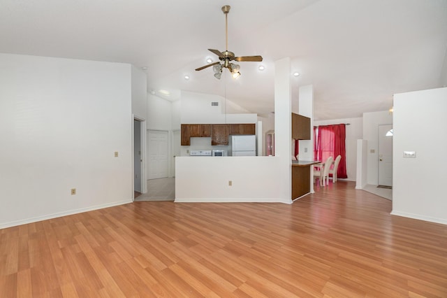 unfurnished living room with ceiling fan, high vaulted ceiling, and light hardwood / wood-style floors