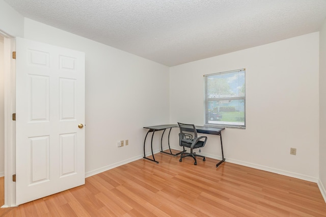 office space with a textured ceiling and light hardwood / wood-style floors