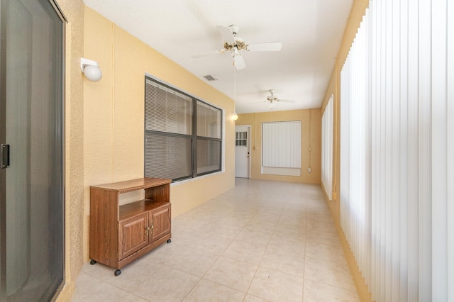 hall featuring light tile patterned flooring