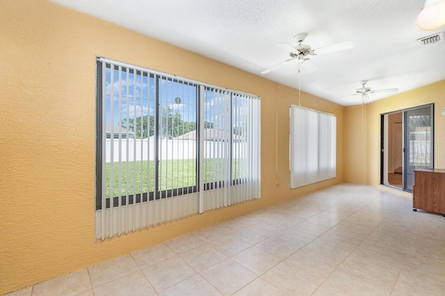 spare room with a textured ceiling and ceiling fan