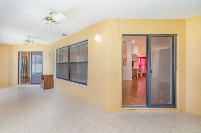 tiled empty room featuring ceiling fan and lofted ceiling