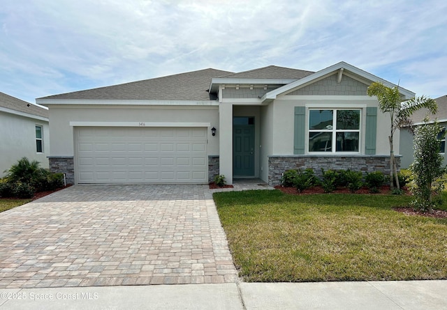 view of front of home with a garage and a front lawn