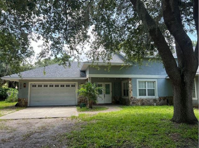 view of front of home with a garage and a front lawn