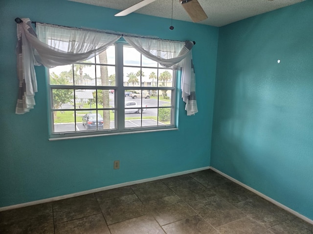 spare room with ceiling fan and a textured ceiling