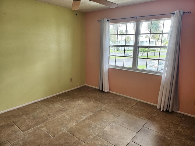 spare room featuring ceiling fan and a textured ceiling