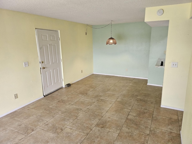 empty room featuring a textured ceiling