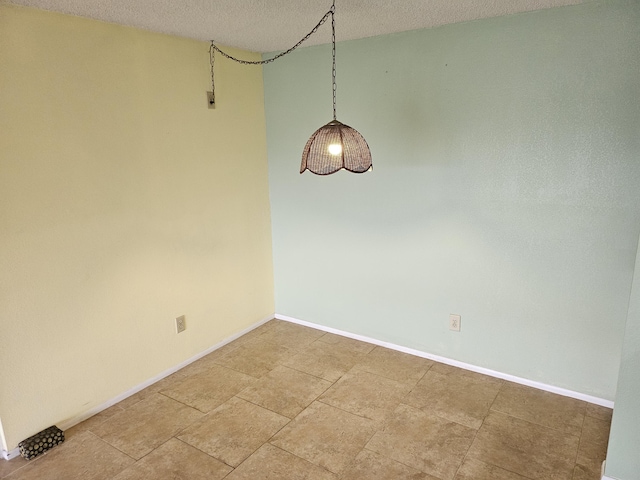 unfurnished room with a textured ceiling