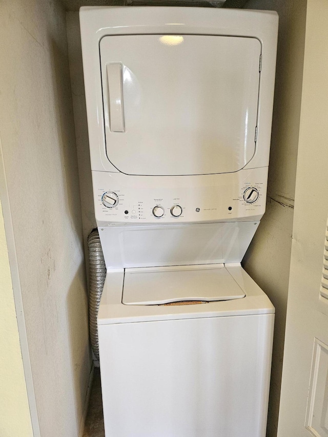 laundry room with stacked washer / drying machine