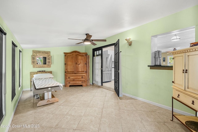 sitting room with ceiling fan and light tile patterned floors