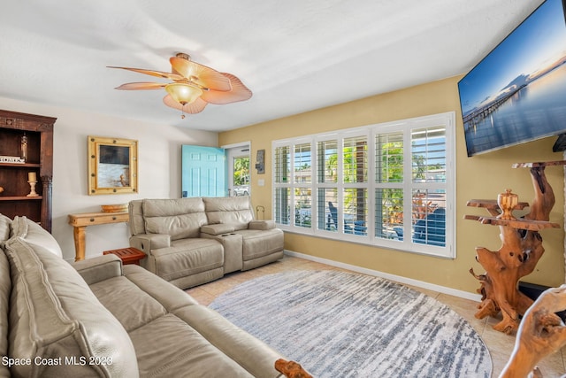 living room featuring light tile patterned floors and ceiling fan