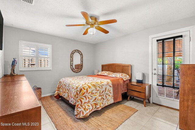 tiled bedroom featuring ceiling fan and access to exterior