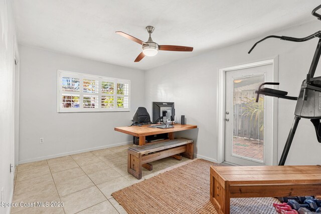 tiled office space featuring ceiling fan