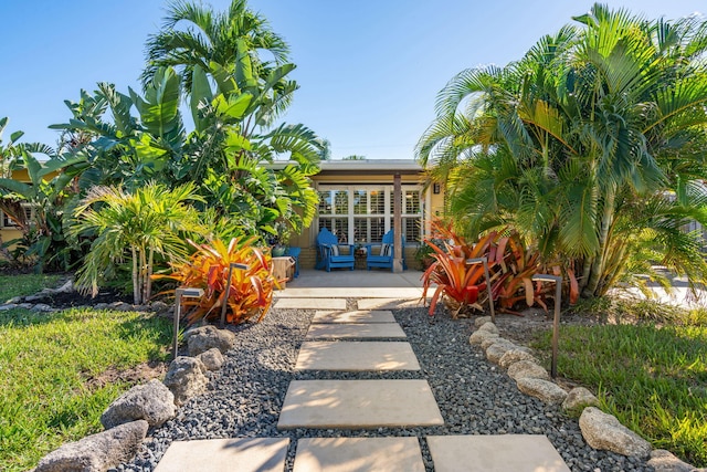 view of exterior entry with french doors and a patio