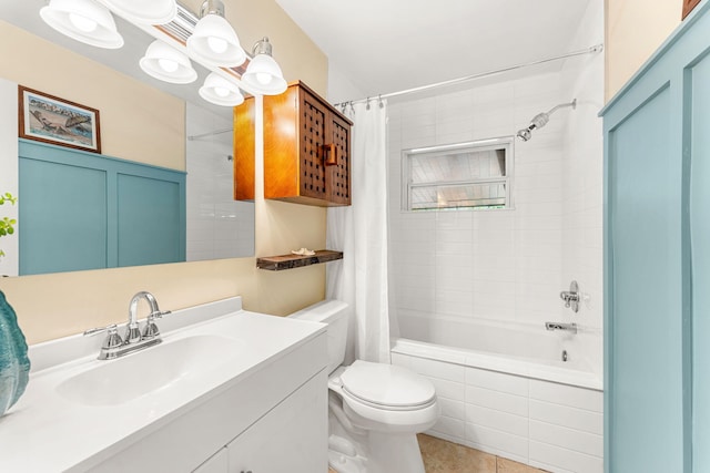 full bathroom featuring tile patterned flooring, vanity, toilet, and shower / bath combination with curtain