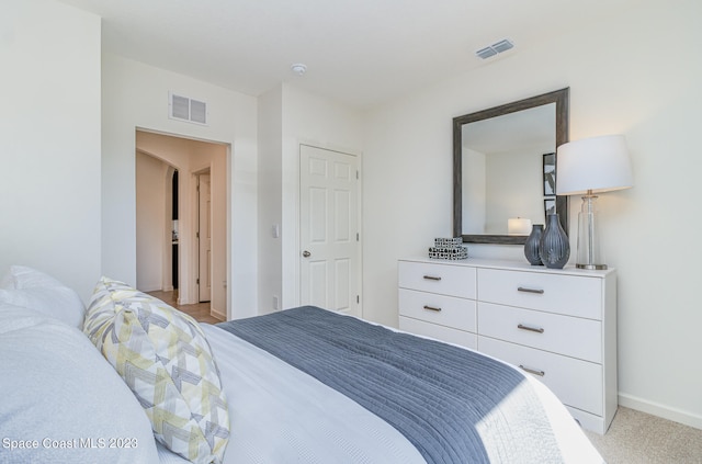 bedroom featuring light colored carpet