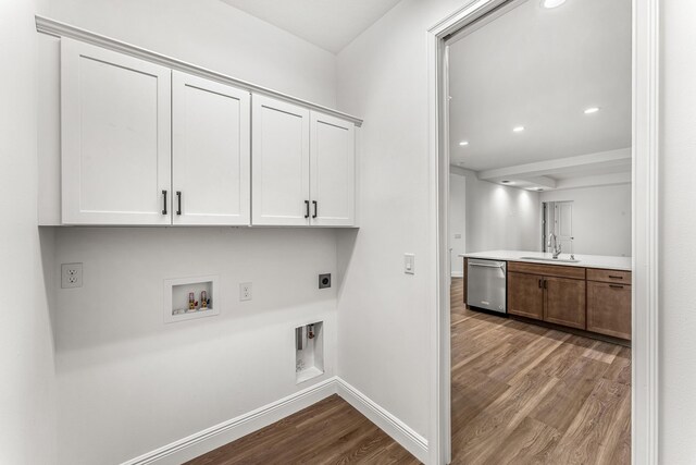 washroom with washer hookup, electric dryer hookup, hardwood / wood-style floors, and sink