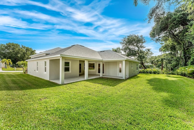 rear view of house featuring a yard and a patio area