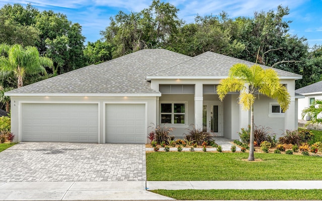 view of front of home featuring a garage and a front yard