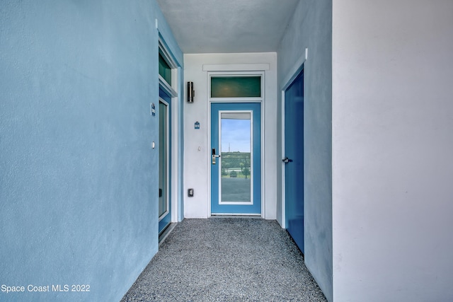 entrance to property with stucco siding