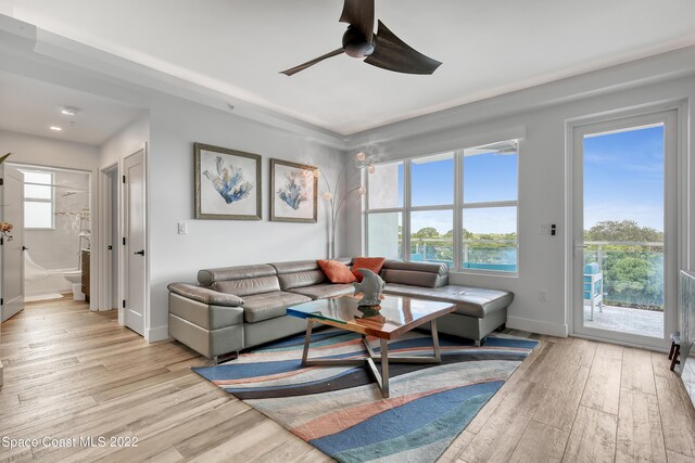 living room featuring light wood-type flooring and ceiling fan