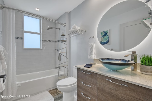 bathroom featuring shower / bath combo, toilet, vanity, and wood finished floors