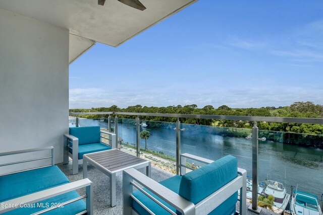 balcony with a water view and an outdoor hangout area